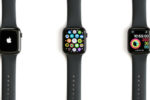 Three smartwatches with black bands displaying different screens: an Apple logo, an app grid, and a fitness tracker with a digital clock.