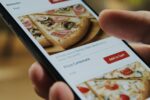 Smartphone fast food online ordering. Choosing pizza on mobile smart phone app.